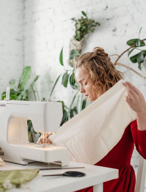 Woman in red dress sewing