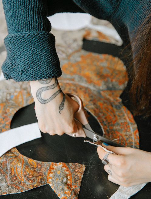 Woman cutting fabric with scissors